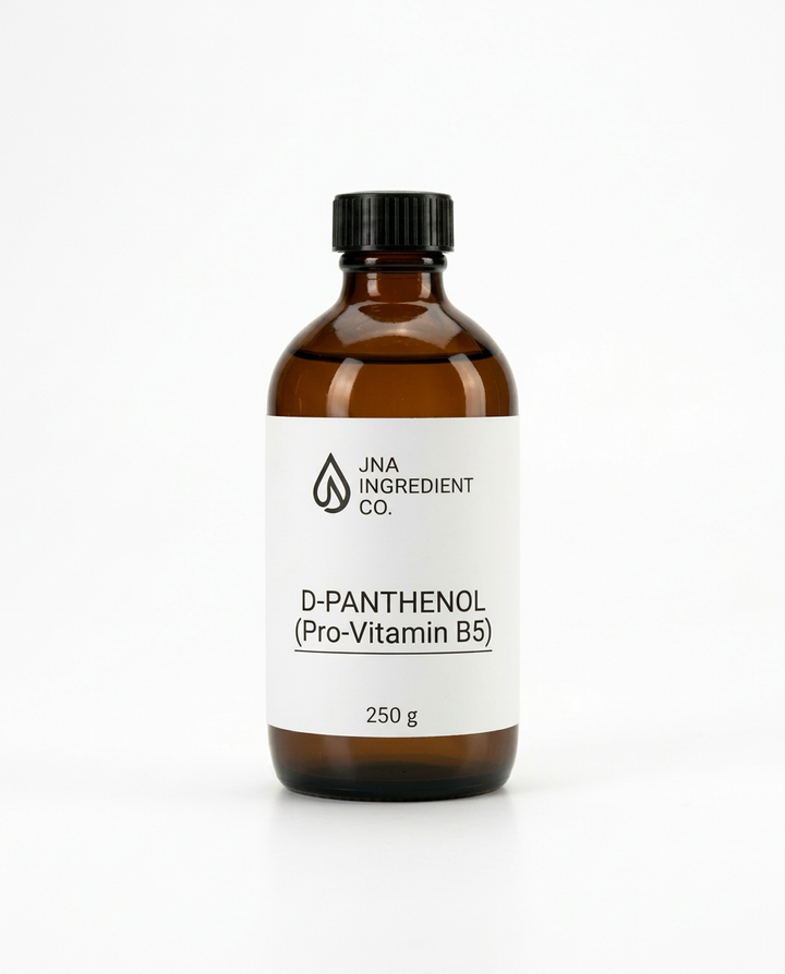 An amber glass bottle with a black cap and a white label reading 'JNA INGREDIENT CO.' and 'D-PANTHENOL (Pro-Vitamin B5)' used for soothing, moisturising, and strengthening sensitive‑skin formulations