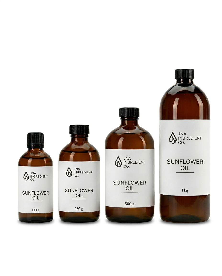 Four amber glass bottles of JNA Ingredient Co. Sunflower Oil in 100g, 250g, 500g, and 1kg sizes, arranged in ascending size order on a clean white reflective surface.