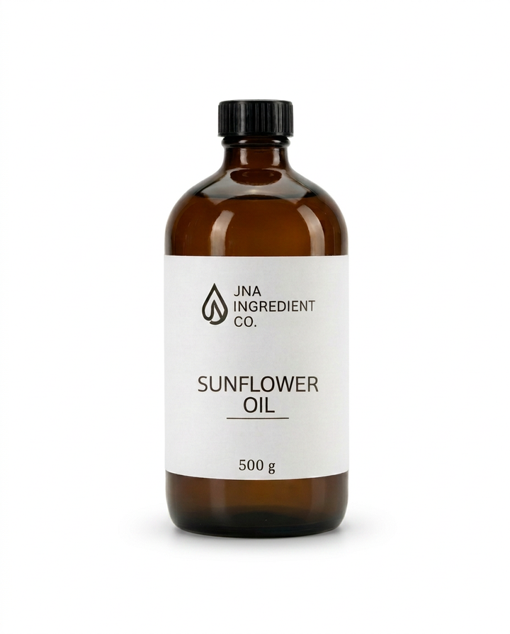 An amber glass bottle of JNA Ingredient Co. Sunflower Oil with a white label and black cap, set against a plain white background. High Oleic Sunflower Oil emollient used in soaps, creams, serums, and body care formulations