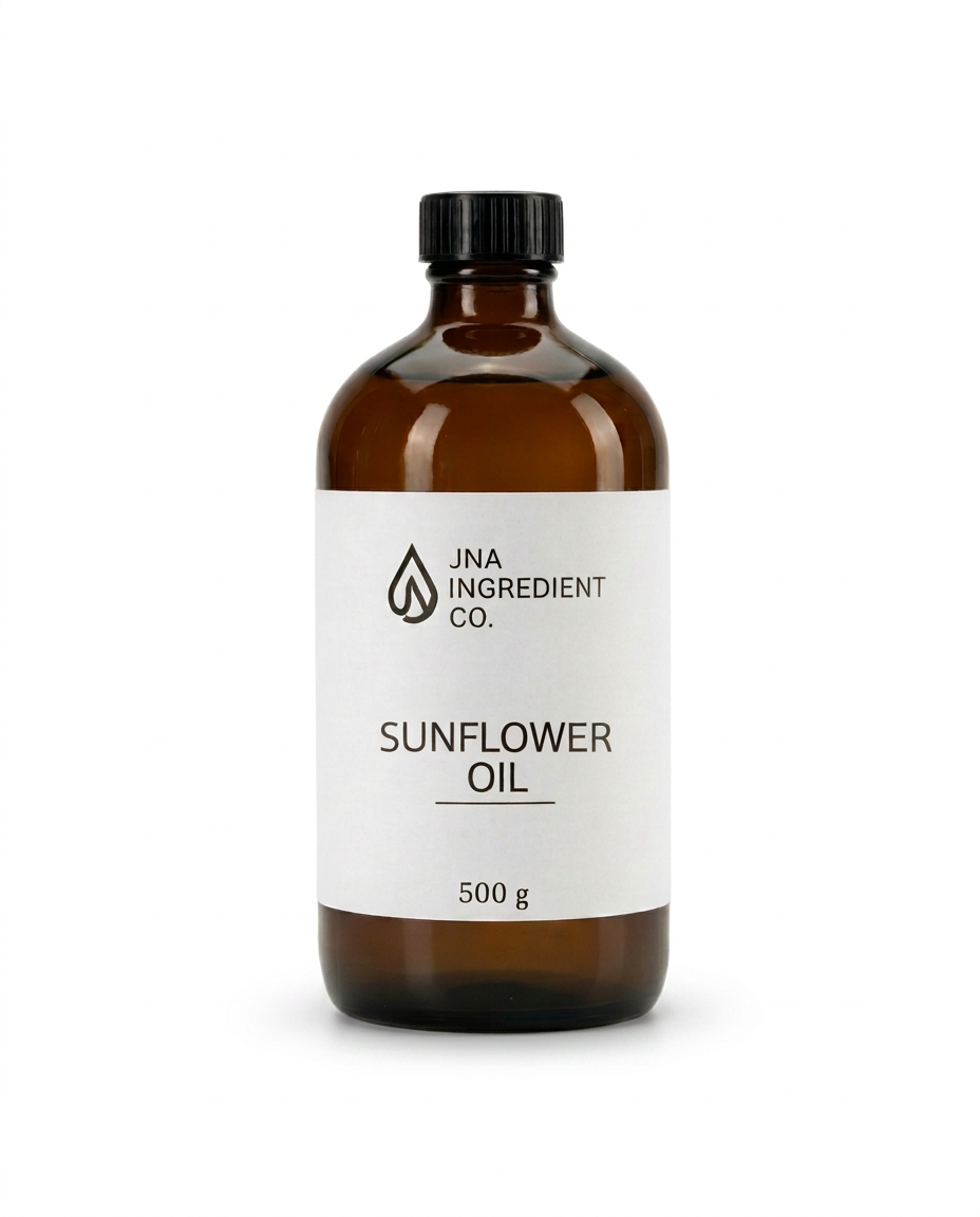 An amber glass bottle of JNA Ingredient Co. Sunflower Oil with a white label and black cap, set against a plain white background. High Oleic Sunflower Oil emollient used in soaps, creams, serums, and body care formulations